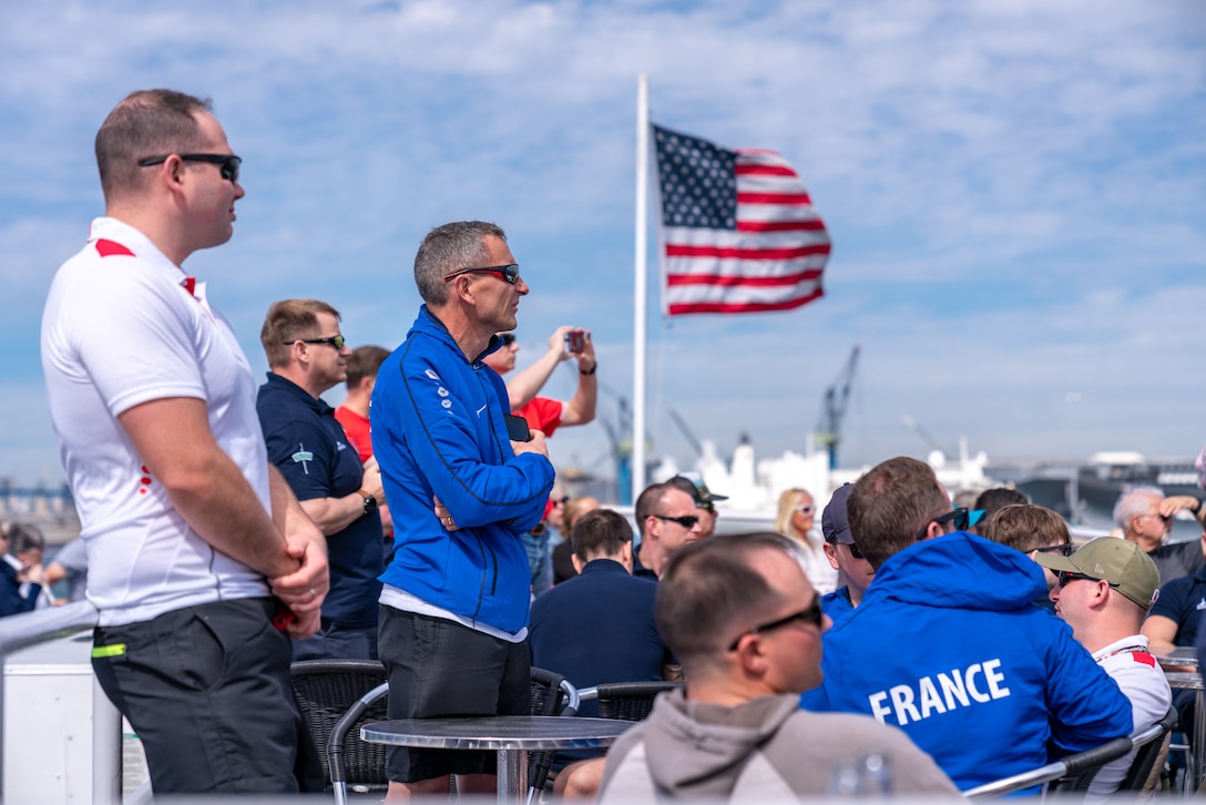 Members of teams from France, United Kingdom, and Canada observe the docking of the ship during the 2020 Marine Corps Trials International Day at San Diego, California, Feb. 28. The Marine Corps Trials promotes recovery and rehabilitation through adaptive sport participation and develops camaraderie among recovering service members and veterans. Additionally, the Trials serve as an opportunity for RSMs to demonstrate physical and mental achievements and as the primary venue to select Marine Corps participants for the DoD Warrior Games.