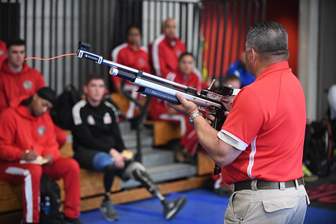 Retired Marine Corps Master Gunnery Sgt. Harry Harrison instructs athletes on how to properly shoot and reload their fitted air powered rifles to prepare for the upcoming marksmanship events during the 2020 Marine Corps Trials at Marine Corps Base Camp Pendleton, Calif., March 1. The Marine Corps Trials promotes rehabilitation through adaptive sports participation for recovering service members and veterans all over the world.