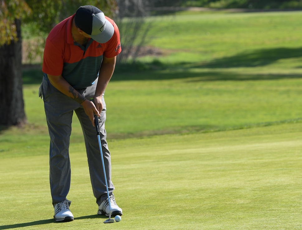 U.S. Marine Corps Staff Sgt. Matthew Castel lines up his shot during the Marine Corps Trials golf tournament at Marine Corps Base Camp Pendleton, Calif., March 4. The Marine Corps Trials promotes recovery and rehabilitation through adaptive sports participation and develops camaraderie among recovering service members.