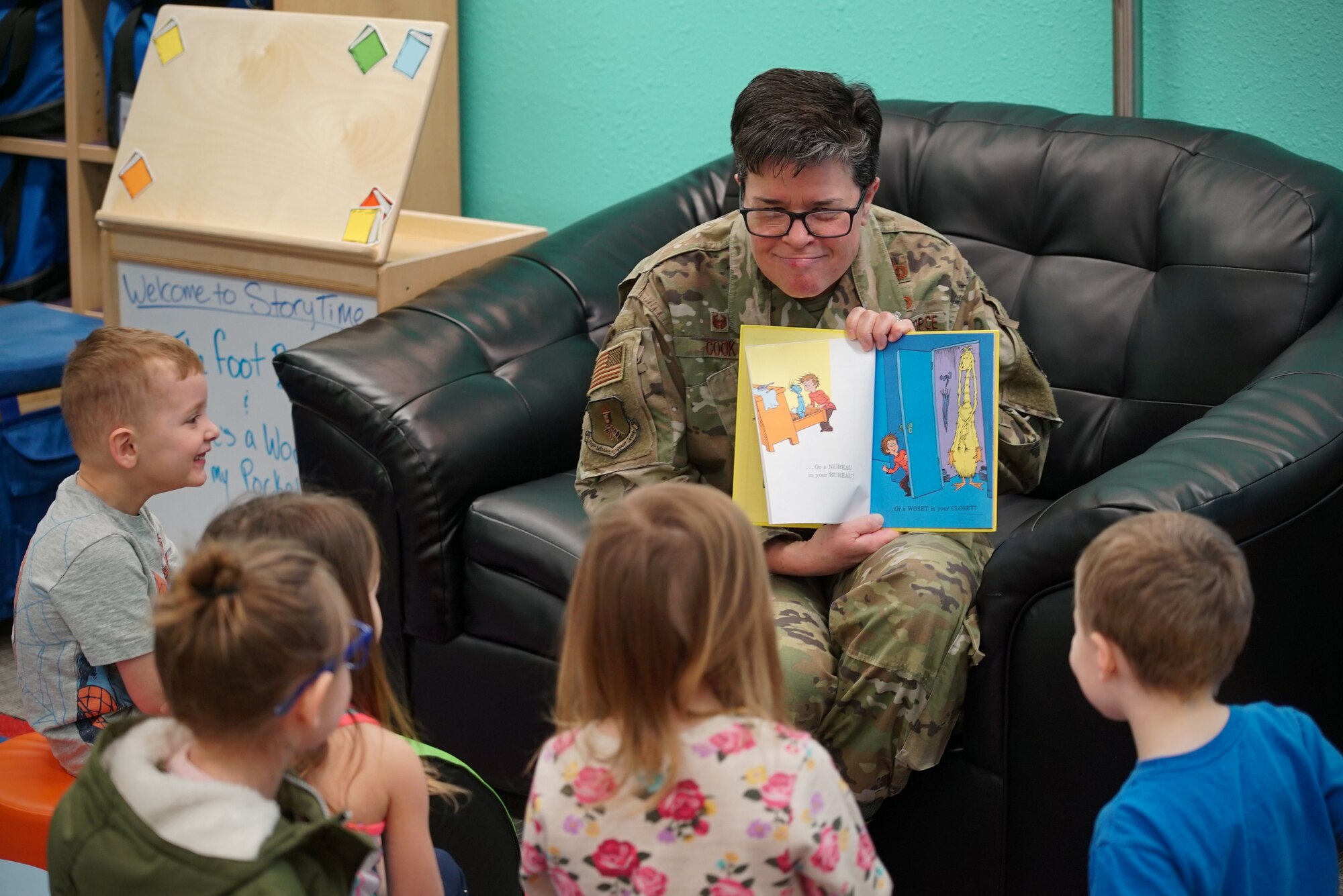Col. Heather Cook, 319th Mission Support Group commander, reads a Dr. Suess book to a group of children March 4, 2020, in the library on Grand Forks Air Force Base, N.D. The story time took place following the library’s grand re-opening ceremony, which celebrated its renovations to include new carpet, shelving, paint and signage. (U.S. Air Force photo by Senior Airman Elora J. McCutcheon)