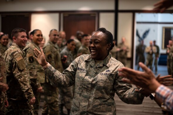 U.S. Air Force Master Sgt. Zina Dromov, 60th Air Mobility Wing Commander's Action Group superintendent, is lauded by her peers during a celebration commending the master sergeants selected to promote to the rank of senior master sergeant March 4, 2020, on Travis Air Force Base, California. Dromov was one of the base’s 23 master sergeants to attain the new rank.