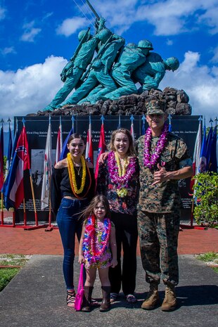 U.S. Marine Corps Sgt. Maj. Alfonso Ramos Jr., off-going sergeant major, Marine Unmanned Aerial Vehicle Squadron 3, and his family pose for a group picture during the VMU-3 relief and appointment ceremony, Marine Corps Base Hawaii, March 4, 2020. Sgt Maj. Alfonso Ramos Jr. relinquished responsibilities to Sgt. Maj. Alejandro Garcia Jr. (U.S. Marine Corps photo by Cpl. Matthew Kirk)