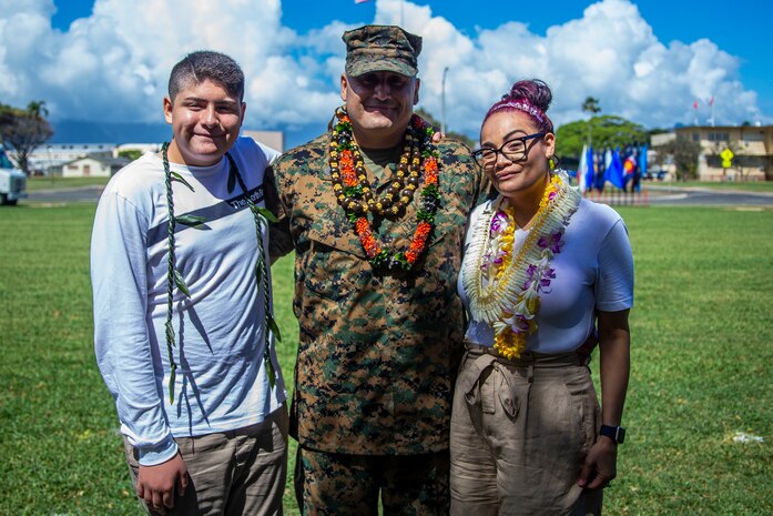 U.S. Marine Corps Sgt. Maj. Robert Ixtlahuac, off-going sergeant major, Headquarters Battalion, Marine Corps Base Hawaii, and his family pose for a photo during the HQBN, MCBH, relief and appointment ceremony, MCBH, March 5, 2020. Sgt. Maj. Robert Ixtlahuac relinquished responsibilities to Sgt. Maj. Alfonso Ramos Jr. (U.S. Marine Corps photo by Cpl. Matthew Kirk)