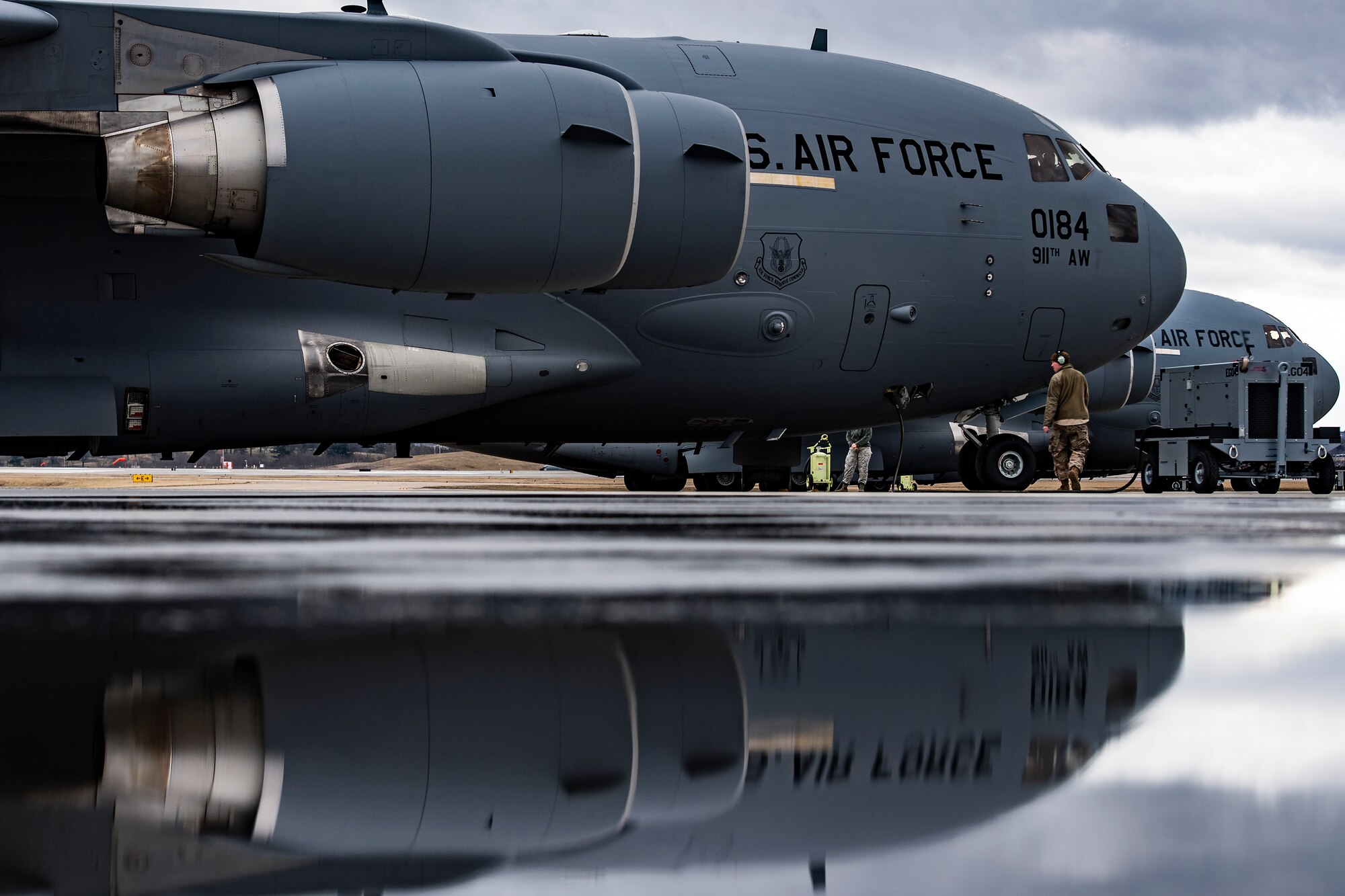 Airmen perform a pre-flight inspection on a C-17 Globemaster III