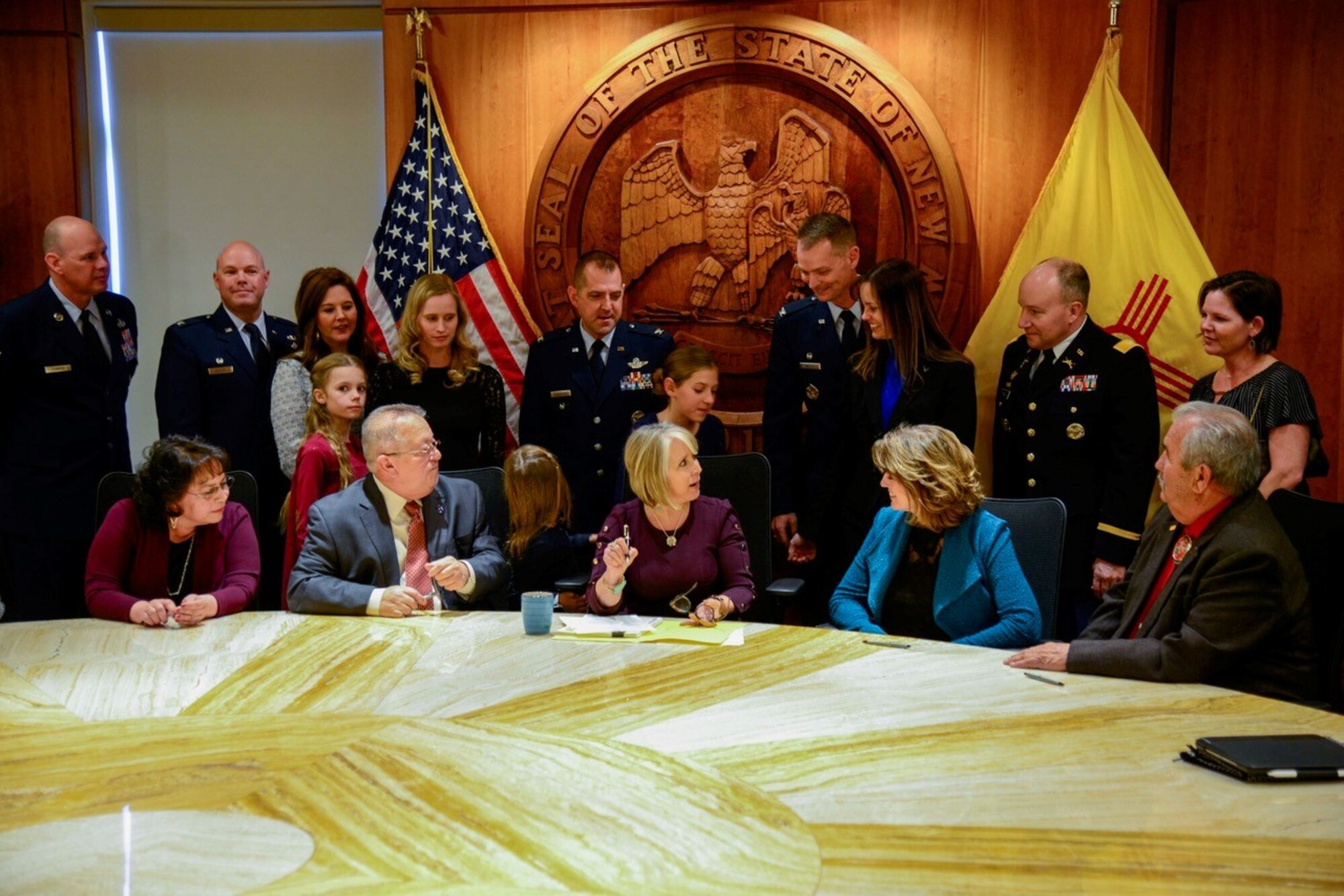 New Mexico Gov. Michelle Lujan Grisham signs HB 30 “Expedited Licensure for Military Families and veterans,” Feb. 26 at the state capitol. The legislation, the culmination of years of work to support reciprocity and ease of occupational licensing for military members, veterans and their families, is expected to come into effect July 1. Representatives from the state legislature, military installations in New Mexico, and civic leaders took part in the signing. (U.S. Air Force photo by Jim Fisher)