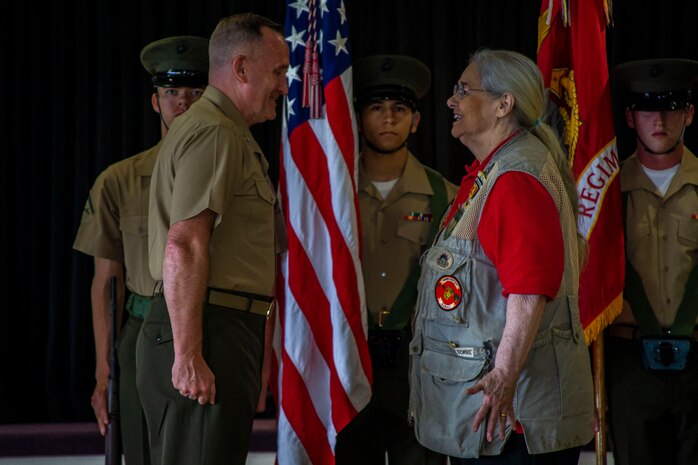 Mrs. Barbara Mathews is bestowed the title of honorary United States Marine by Maj. Gen. William M. Jurney, commanding general, 3rd Marine Division, III Marine Expeditionary Force, during an Honorary Marine ceremony, Marine Corps Base Hawaii, March 6, 2020. The Honorary Marine title is designed to reinforce the special bond between the American people and the Marine Corps by recognizing individuals in the civilian community who have made extraordinary contributions to the Marine Corps. Mrs. Mathews earn this prestigious honor for volunteering over 10 years of her personal time, talents and money capturing photo and video of hundreds of Marine Corps ceremonies, including memorials and special events surrounding the wars in Iraq and Afghanistan. (U.S. Marine Corps photo by Cpl. Matthew Kirk)
