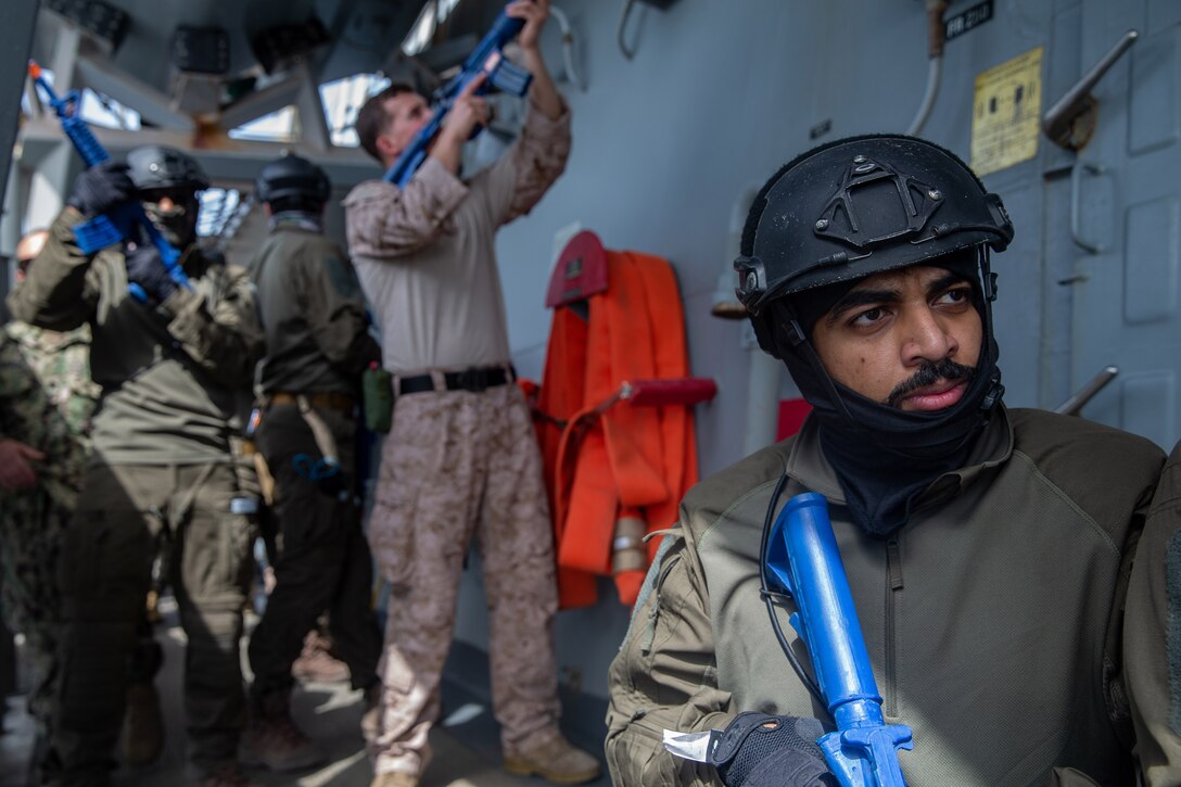 An operator with the United Arab Emirates’ (UAE) Critical Infrastructure and Coastal Protection Agency waits for a signal to advance while conducting Visit, Board, Search, and Seizure training aboard the U.S.S. Forrest Sherman (DDG 98) during exercise Iron Defender 20 in the Arabian Gulf, March 2, 2020. Iron Defender 20 is a U.S. Naval Forces Central Command led bilateral exercise between the U.S. Navy, U.S. Coast Guard, and the UAE naval and air defense forces. Iron Defender 20 allows the U.S. Armed Forces to train bilaterally with the UAE Armed Forces to enhance maritime interoperability and strengthen our maritime security posture. (U.S. Marine Corps photo by Lance Cpl. Brendan Mullin)