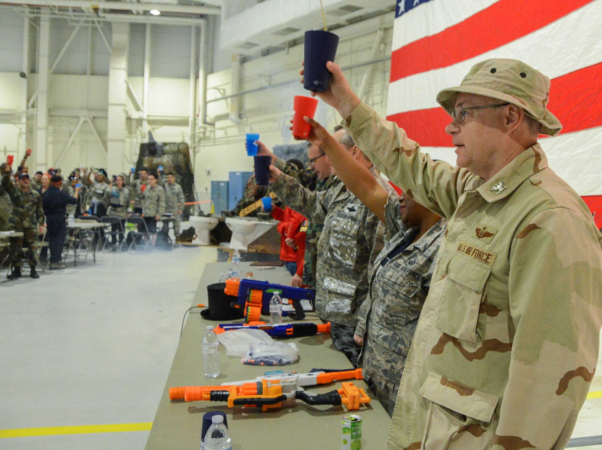 Texas Air National Guard Airmen lift their cups in toasts.