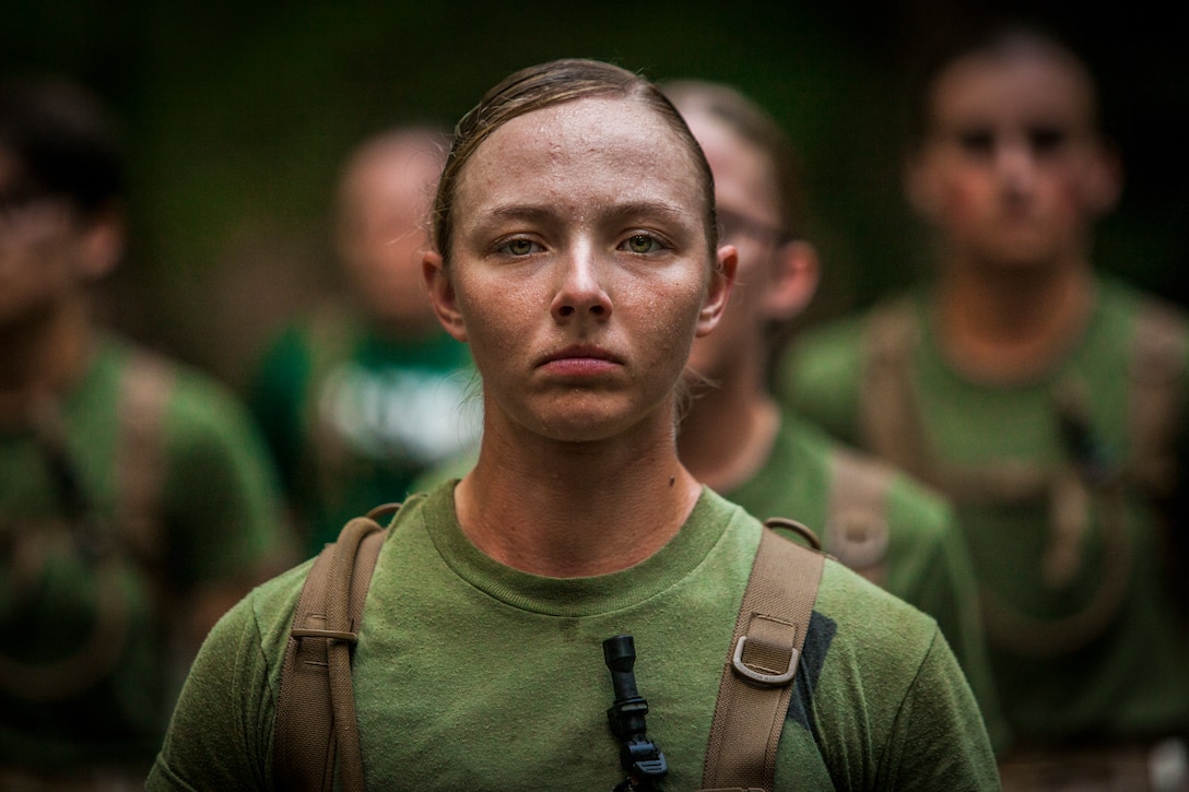 An officer candidate stands at attention during the Medal of Honor run at Officer Candidates School aboard Marine Corps Base Quantico, Virginia, August 15, 2019. The mission of Officer Candidates School is to educate and train officer candidates in Marine Corps knowledge and skills within a controlled and challenging environment in order to evaluate and screen individuals for the leadership, moral and physical qualities required for commissioning as a Marine Officer.