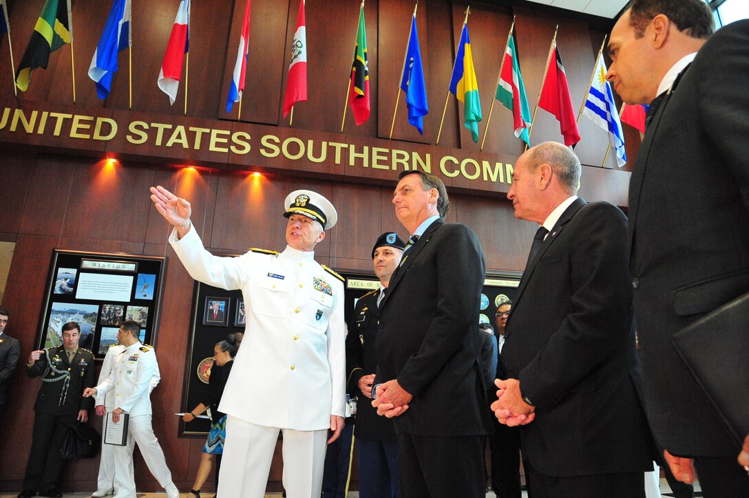 Jair Bolsonaro talks with Navy Adm. Craig Faller in Miami.