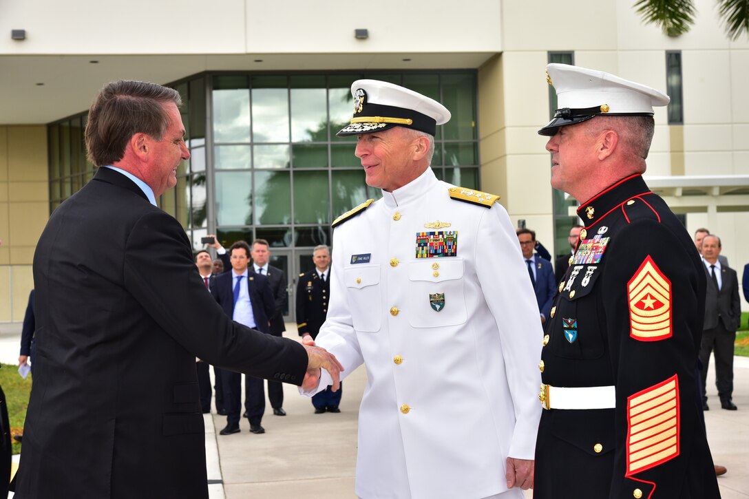 Brazilian President Jair Bolsonaro arrives at U.S. Southern Command headquarters and is greeted by Navy Adm. Craig Faller.