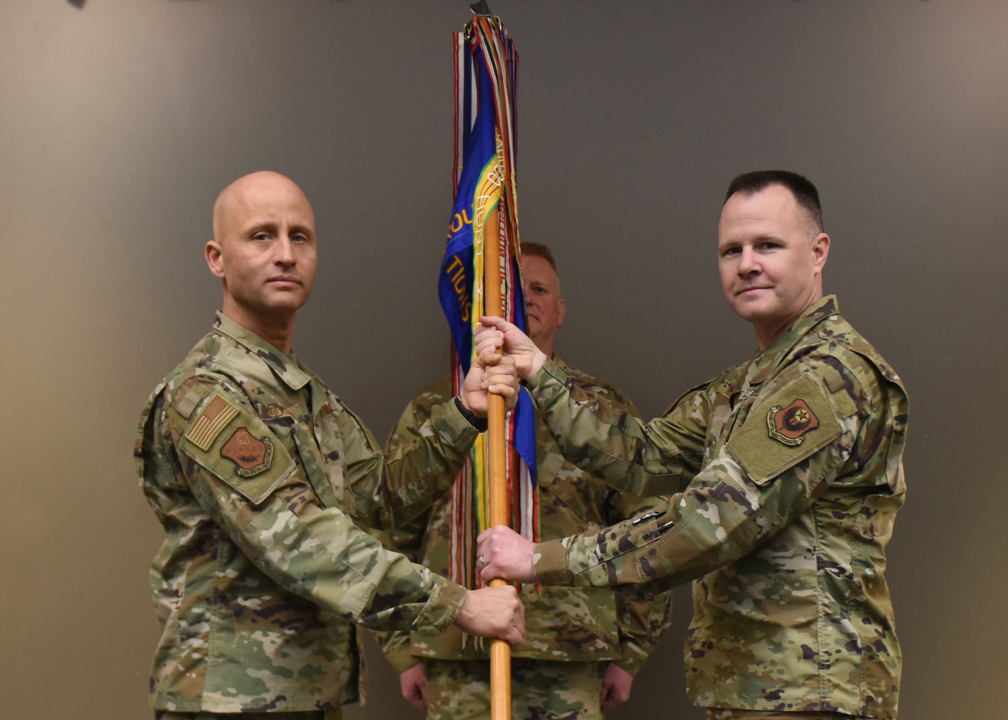 U.S. Air Force Lt. Col. Dereck Rodgers (right),193rd Special Operations Group commander accepts a guidon from Col. Terrence Koudelka,193rd Special Operations Wing commander, during an assumption of command ceremony March 7, 2020, in Middletown, Pennsylvania. The ceremony began with preliminary honors and ended with the symbolic passing of the guidon. (U.S. Air National Guard photo by Staff Sgt. Rachel Loftis/Released)