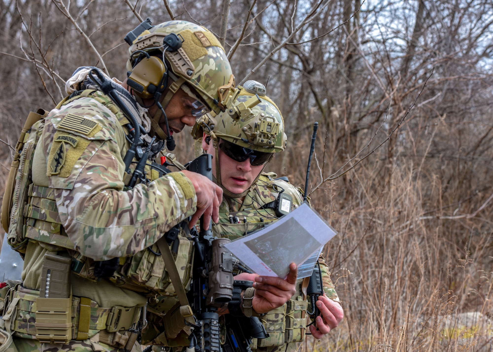 U.S. Air Force Staff Sgt. Kerry Martin (left) and Senior Airman Anthony Severo, 148th Air Support Operations Squadron, Tactical Air Control Party Specialists, look over information as part of a training exercise at Fort Indiantown Gap, Feb. 9, 2020, in Annville, Pennsylvania. Field training exercises allow Airmen the opportunity to showcase and hone their skills to ensure they are successful when in real-world situations. (U.S. Air National Guard photo by Staff Sgt. Rachel Loftis/Released)