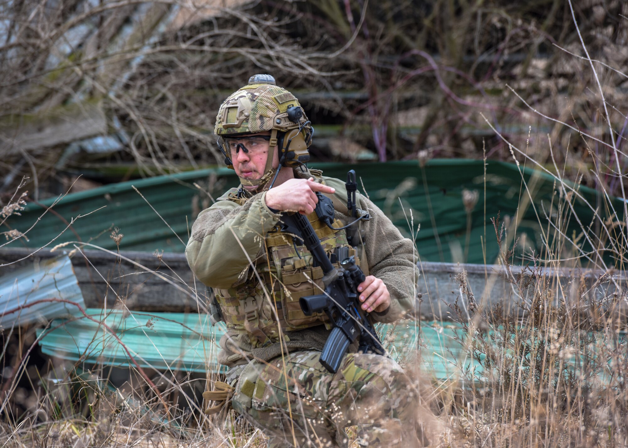 U.S. Air Force Staff Sgt. James Montague, 148th Air Support Operations Squadron, Tactical Air Control Party Specialist, motions to members of his unit during a training exercise at Fort Indiantown Gap, Feb. 9, 2020, in Annville, Pennsylvania. Field training exercises allow Airmen the opportunity to showcase and hone their skills to ensure they are successful when in real world situations. (U.S. Air National Guard photo by Staff Sgt. Rachel Loftis/Released)