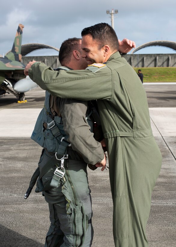 Lt. Col. Julio Rodriguez (left) and his brother Lt. Col. Antonio Rodriguez (right) hug before Julio’s flight in an F-16C Fighting Falcon, February 27, 2020 at Andersen Air Force Base, Guam.