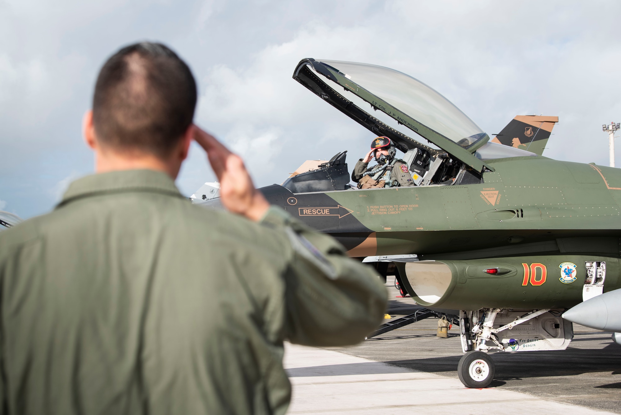 Lt. Col. Julio Rodriguez salutes his brother Lt. Col. Antonio Rodriguez before takeoff in an F-16C Fighting Falcon February 27, 2020 at Andersen Air Force Base, Guam.