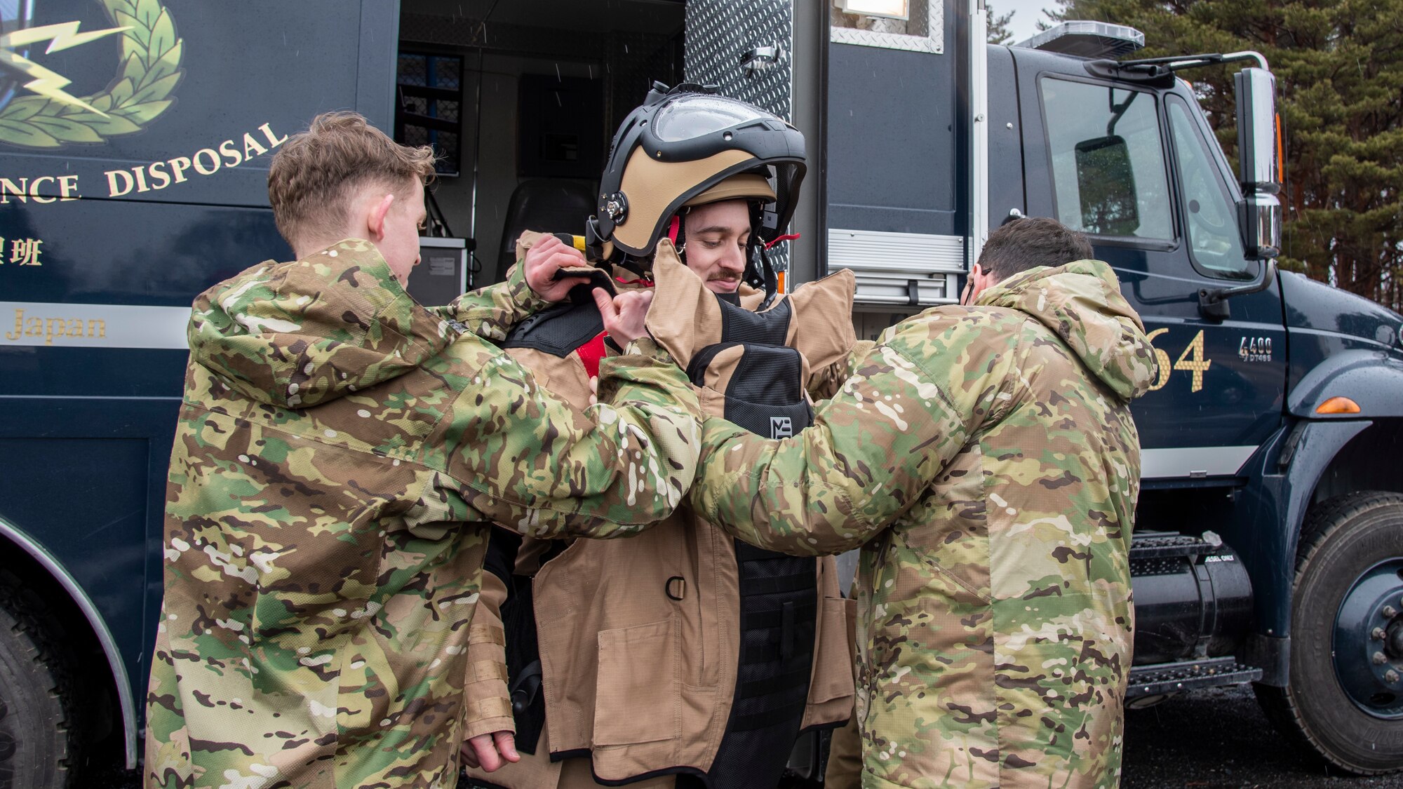 U.S. Air Force Staff Sgt. Tanner Connally, a 35th Civil Engineer Squadron Explosive Ordnance Disposal journeyman, receives help putting on a bomb suit at Misawa Air Base, Japan, March 3, 2020. The bomb suit contains heavy body armor made to withstand the pressure caused by a bomb explosion and any debris it produces. (U.S. Air Force photo by Airman 1st Class China M. Shock)