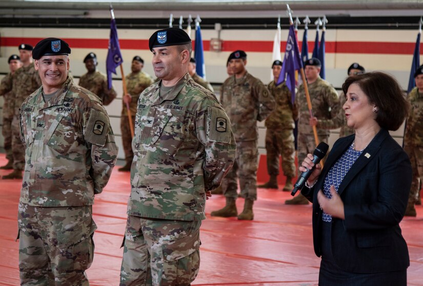 The honorable Nellie Gorbea, Rhode Island Secretary of State, right, offers words of thanks to both Col. Bradley A. Heston, center, and Col. Carlos E. Gorbea, for their service to the United States of America, during the 361st Civil Affairs Brigade change of command ceremony held on Kleber Kaserne in Kaiserslautern, Germany, March 7, 2020.