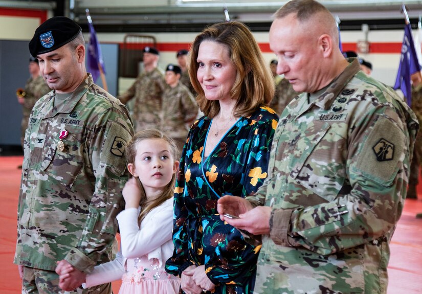 Brig. Gen. Michael T. Harvey, right, commander of the 7th Mission Support Command, recognizes the sacrifices made by family members while honoring Ann-Hilary and Evelyn, wife and daughter of Col. Bradley A. Heston, outgoing commander of the 361st Civil Affairs Brigade, prior to Heston’s change of command ceremony held on Kleber Kaserne in Kaiserslautern, Germany, March 7, 2020.