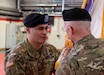Col. Carlos E. Gorbea, left, incoming commander of the 361st Civil Affairs Brigade, passes the unit colors to Command Sgt. Maj. Michael S. McGregor, during a change of command ceremony held on Kleber Kaserne in Kaiserslautern, Germany, March 7, 2020.