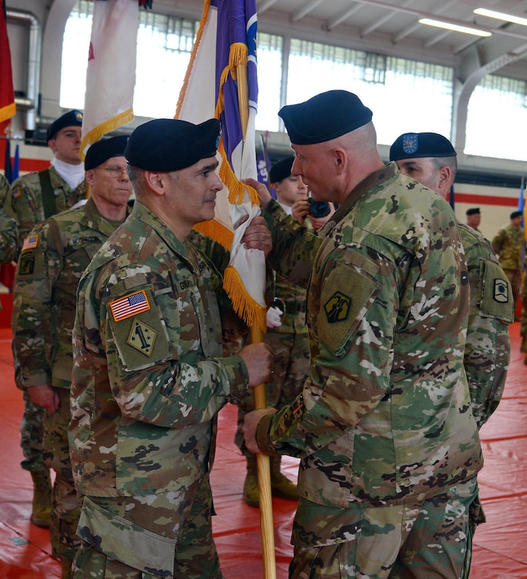 Brig. Gen. Michael T. Harvey, right, commander of the 7th Mission Support Command, passes the unit colors to Col. Carlos E. Gorbea, incoming commander of the 361st Civil Affairs Brigade, during a change of command ceremony held on Kleber Kaserne in Kaiserslautern, Germany, March 7, 2020. (Photo by Elisabeth Paqué, Visual Information Specialist)