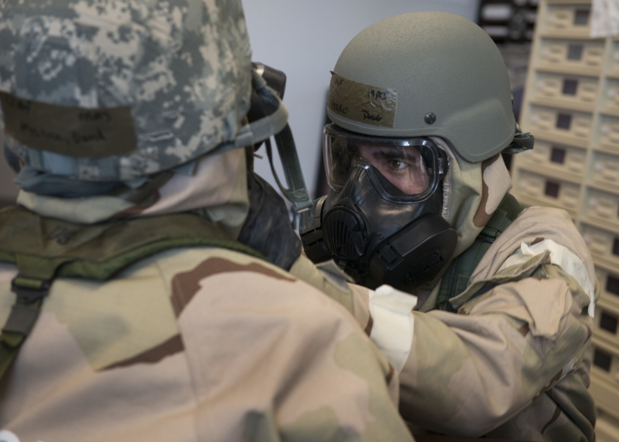 U.S. Air Force Maj. Doug Ferro, 118th Airlift Squadron pilot, 103rd Airlift Wing, Connecticut Air National Guard, checks Maj. David Monico’s Mission Oriented Protective Posture (MOPP) gear during a large-scale readiness exercise at Bradley Air National Guard Base, East Granby, Conn. March 5, 2020. The exercise tested the 103rd Airlift Wing’s ability to deploy to and sustain in a contested environment. (U.S. Air National Guard photo by Staff Sgt. Steven Tucker)