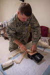 Master Sgt. Robert Hall, with the 124th Logistics Readiness Squadron assigned to the petroleum, oil and lubricant section, practices packing a wound during Tactical Combat Casualty Care training, March 8, 2020, at Gowen Field, Idaho. The hands-on training gives Airmen the skills and experience to deal with blast injuries, gunshot wounds and other types of trauma.