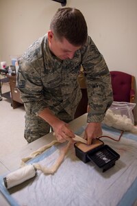 Master Sgt. Robert Hall, with the 124th Logistics Readiness Squadron assigned to the petroleum, oil and lubricant section, practices packing a wound during Tactical Combat Casualty Care training, March 8, 2020, at Gowen Field, Idaho. The hands-on training gives Airmen the skills and experience to deal with blast injuries, gunshot wounds and other types of trauma.