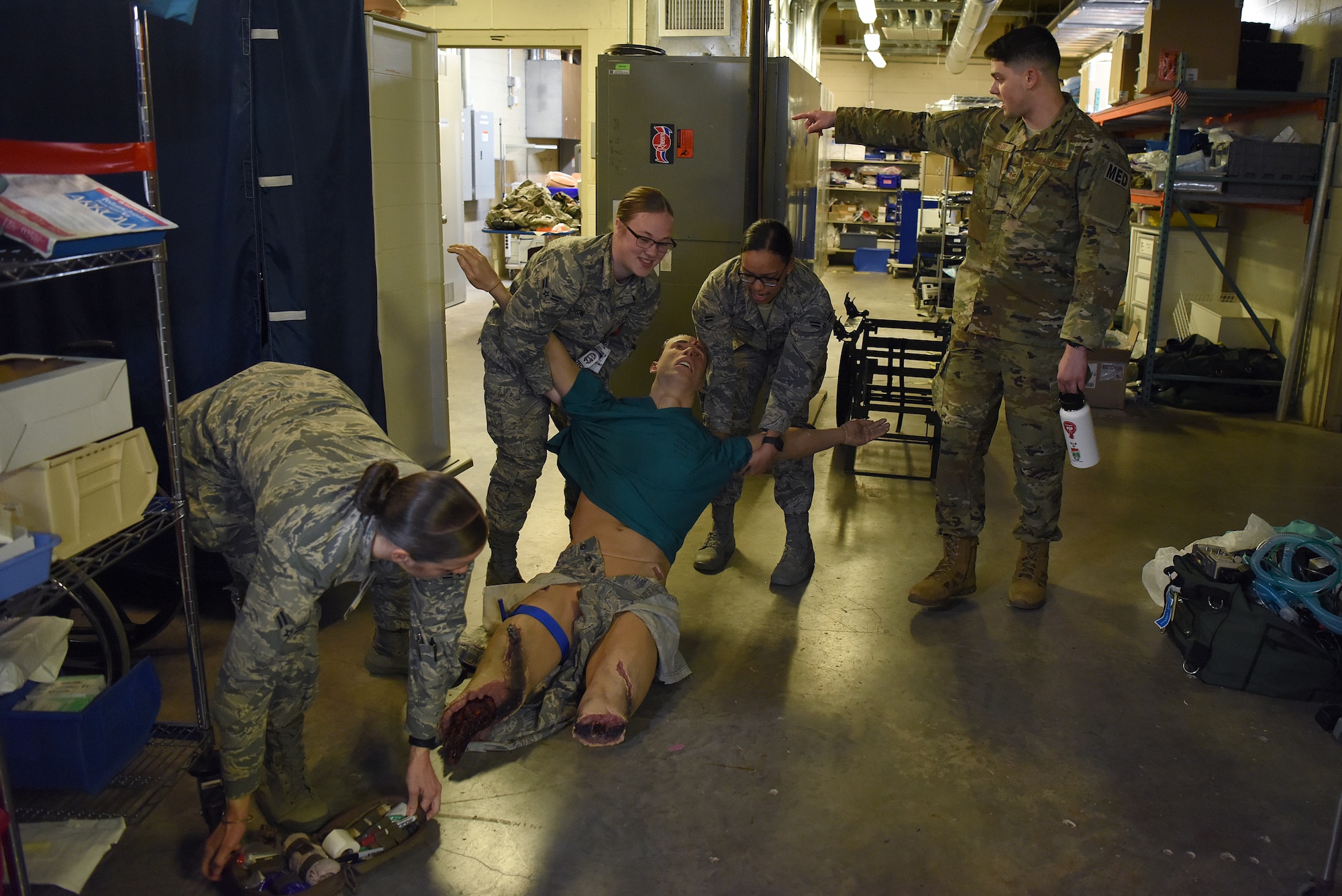 Tactical Combat Casualty Course students practice moving a manikin to safety during a test inside Keesler Medical Center at Keesler Air Force Base, Mississippi, Feb. 20, 2020. The TCCC is replacing self-aid and buddy care to better prepare medics for deployed environments. The course includes two classroom days where they learn about medications, how and when to treat a person when under fire and a third day where they are evaluated on everything they learned with a final scenario. (U.S. Air Force photo by Senior Airman Suzie Plotnikov)