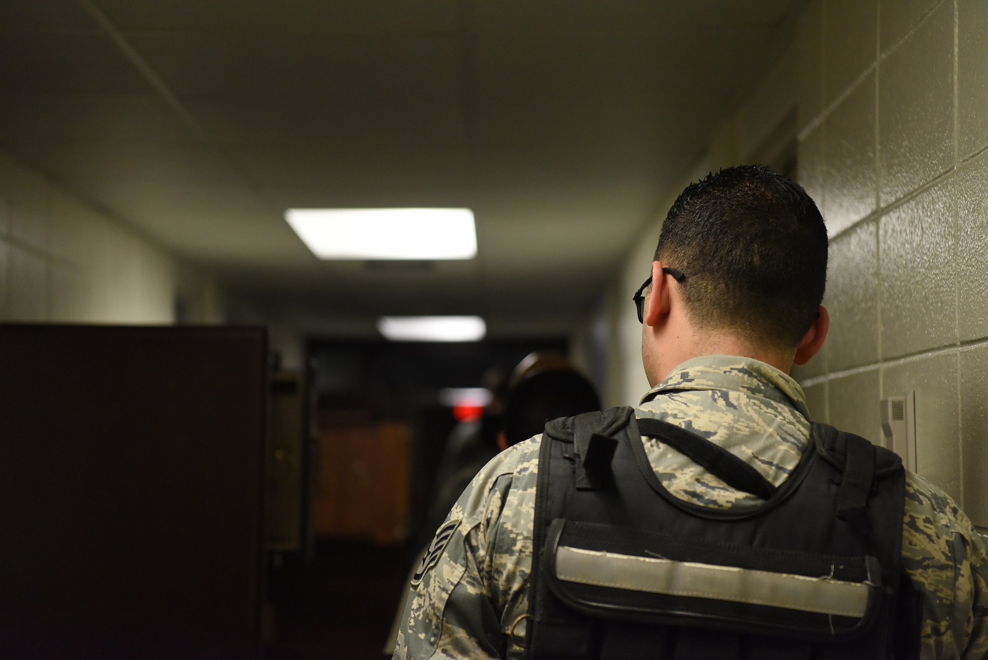 Tactical Combat Casualty Course students walk to the destination of their final exam inside the Locker House at Keesler Air Force Base, Mississippi, Feb. 20, 2020. The TCCC is replacing self-aid and buddy care to better prepare medics for deployed environments. The course includes two classroom days where they learn about medications, how and when to treat a person when under fire and a third day where they are evaluated on everything they learned with a final scenario. (U.S. Air Force photo by Senior Airman Suzie Plotnikov)