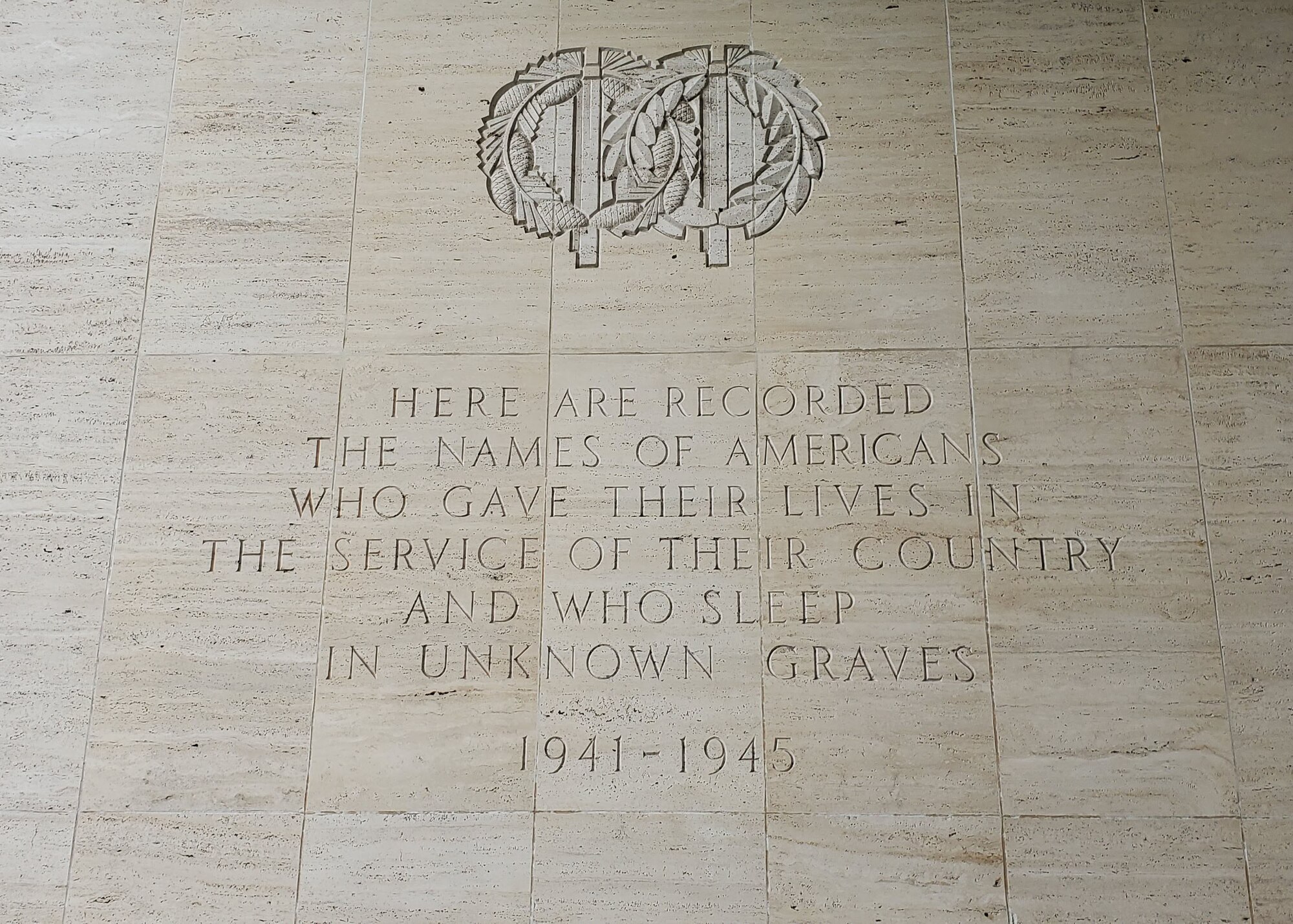 A marble wall with a quote engraved in it.