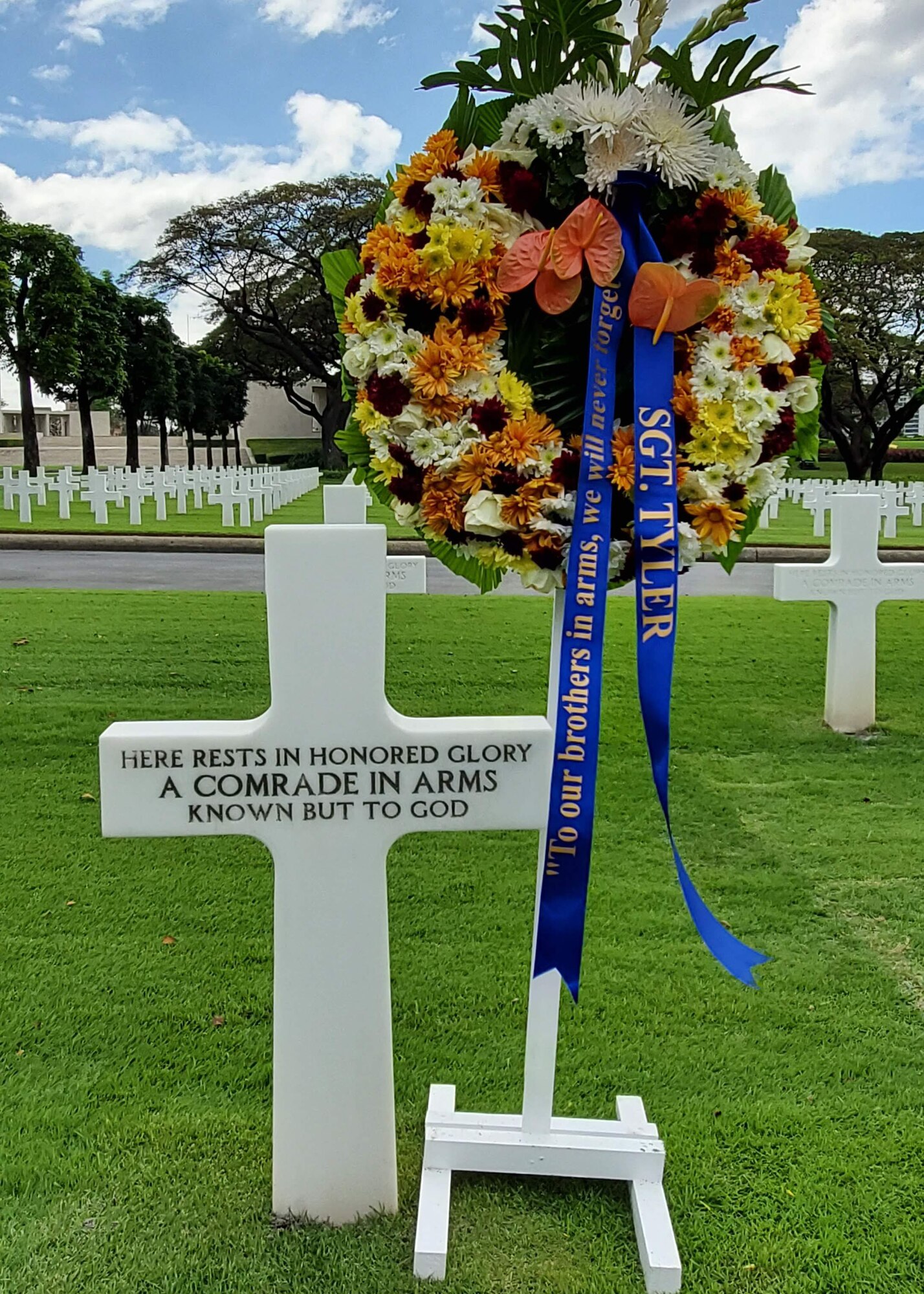 A wreath sits next to an unmarked headstone.
