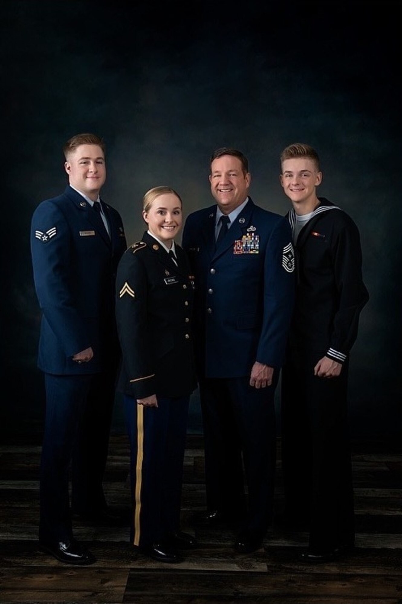U.S. Air Force Senior Airman Everett Brown, traffic management specialist, 124th Logistics Readiness Squadron; Cpl. Kassandra Brown, ammunitions specialist, G Company, 145th Brigade Support Battalion; Command Chief Master Sgt. Sid Brown, State Command Chief, Idaho Air National Guard; and Seaman Wesley Brown, hospital corpsman, Wayne Caron Clinic, Camp Lejeune, North Carolina, pose for a family photo. (Courtesy Photo)