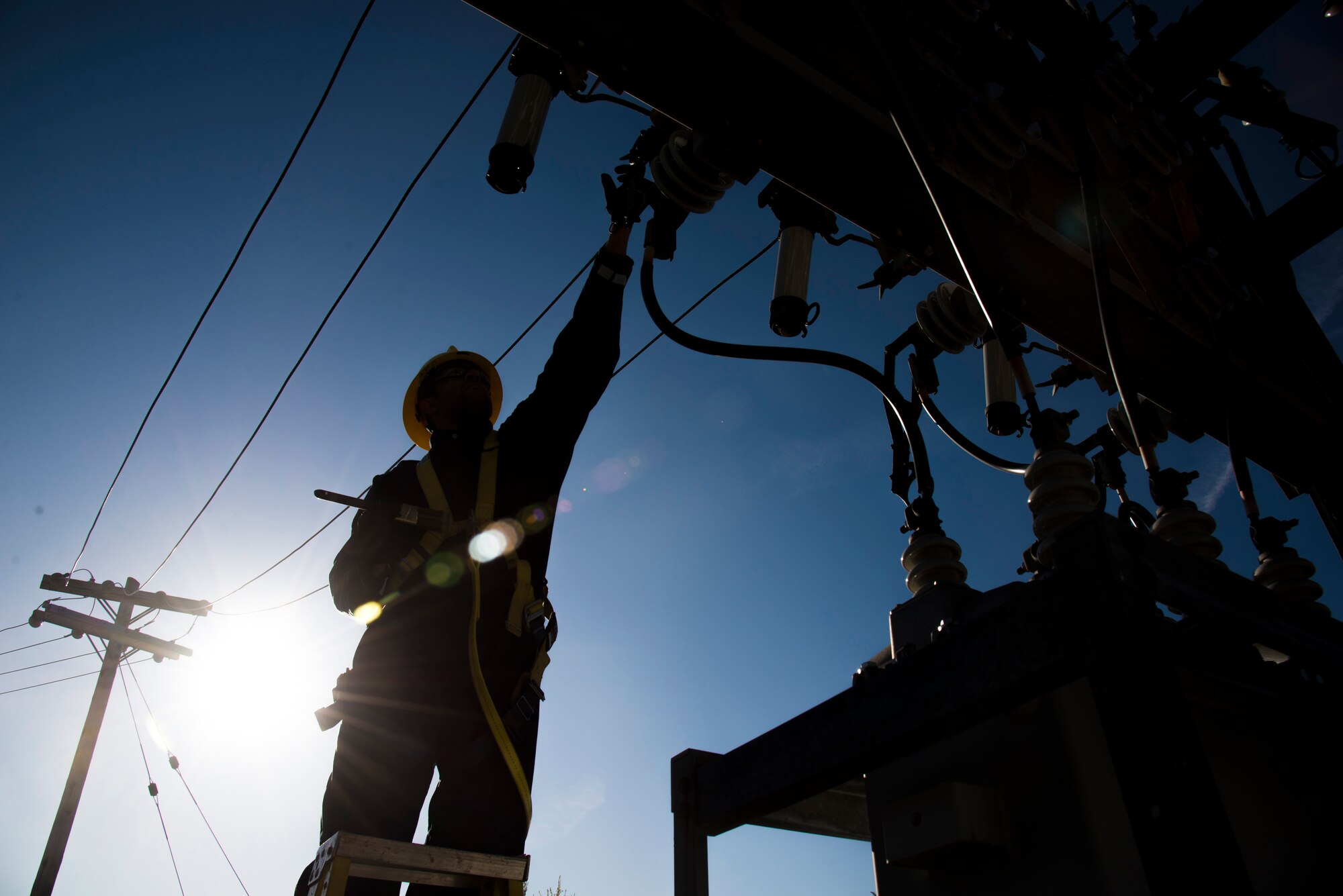 Staff Sgt. Manoj Williams, 375th Civil Engineering Squadron electrical systems craftsman, greases substation 6 framework knife blades and addresses tightening loose conductor connections April 9, 2016 at Scott Air Force Base.