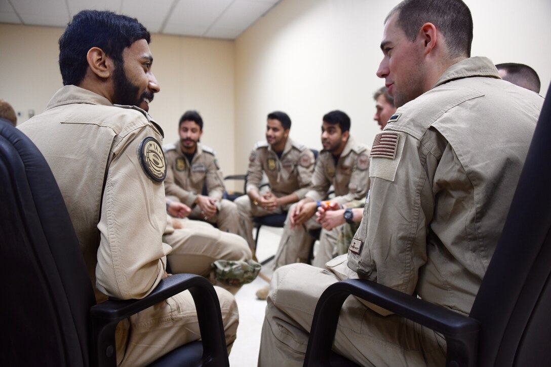 U.S. Air Force and Royal Saudi Air Force E-3 Sentry aircrew members discuss a variety of mission topics during a meet and greet on Prince Sultan Air Base, Kingdom of Saudi Arabia, March 3, 2020. The E-3 and its aircrew are forward deployed to PSAB from Al Dhafra Air Base, United Arab Emirates, as part of an agile combat employment mission meant to test their ability to conduct missions in the region from an austere location. (U.S. Air Force photo by Tech Sgt. Michael Charles)