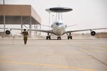 U.S. Air Force Senior Airman Shane Ice, 380th Expeditionary Maintenance Squadron crew chief taxies an E-3 Sentry, on the flight line at Prince Sultan Air Base, Kingdom of Saudi Arabia on March 1, 2020. The E-3s forward deployed to PSAB from Al Dhafra Air Base, United Arab Emirates, as part of an agile combat employment mission meant to test the squadron’s ability to conduct missions in the region from an austere location. (U.S. Air Force photo by Tech Sgt. Michael Charles)