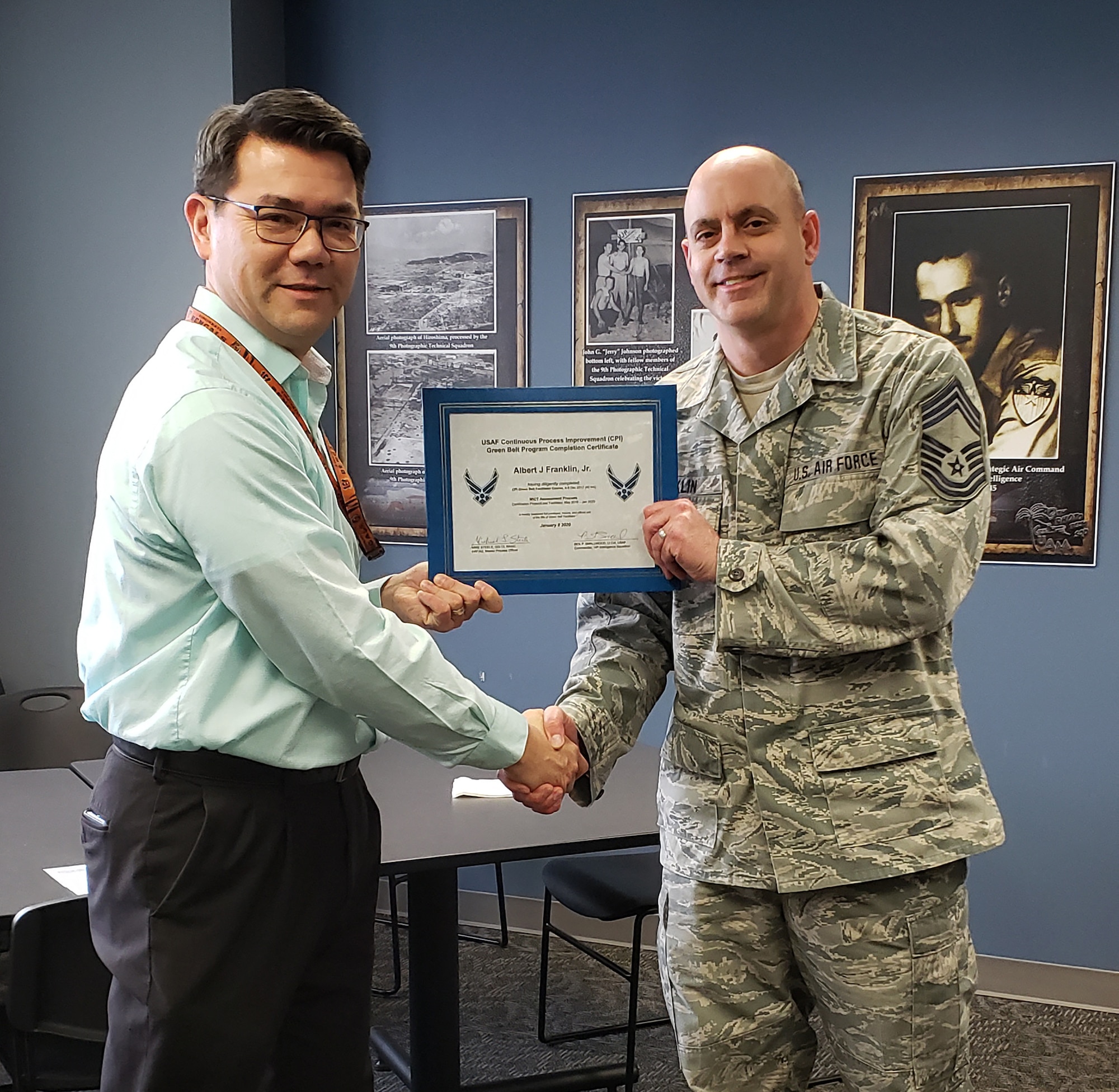 Mr. Michael Steele, National Air and Space Intel Center process manager, presents the USAF Continuous Process Improvement Green Belt Program Completion Certificate to Chief Master Sgt. Albert Franklin, 14th Intelligence Squadron, earlier this year. Green Belt is part of the Air Force Continuous Improvement Process, which increases operational capabilities while reducing associated costs by applying proven techniques to all processes associated with fulfilling the Air Force mission.