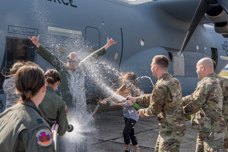 Airmen pour champagne on a retiring airman.