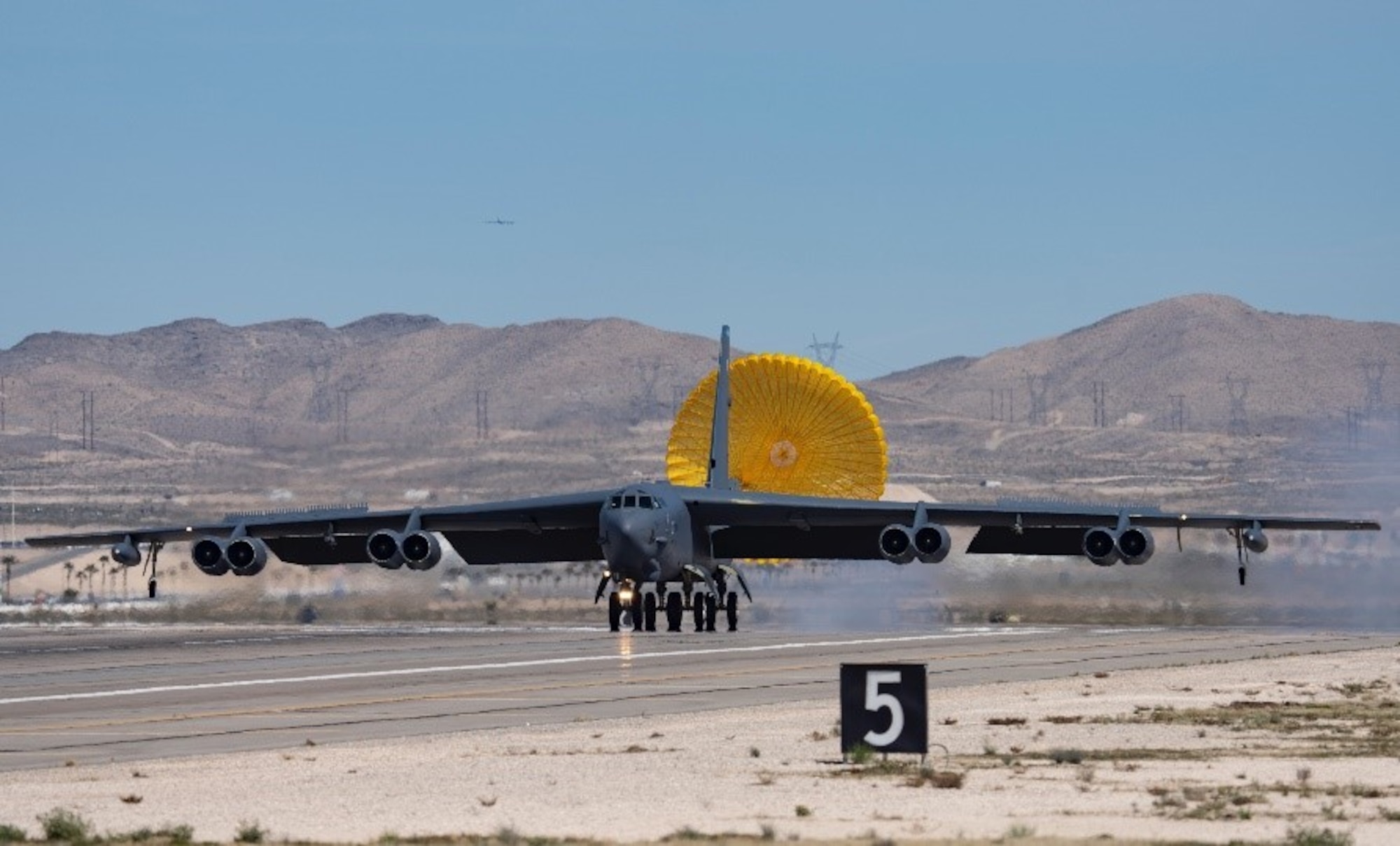 An aircraft taxis down runway.