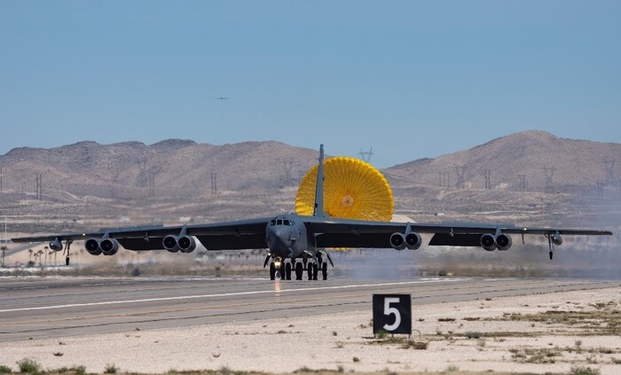 An aircraft taxis down runway.