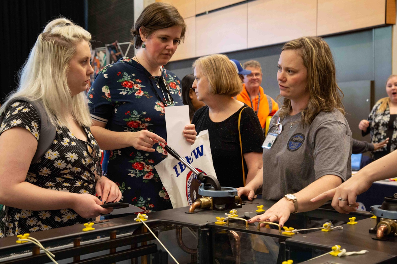 Michelle Berger (right) represents Puget Sound Naval Shipyard & Intermediate Maintenance Facility at the 2019 Seattle Women in Trades fair.