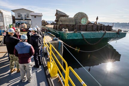 PSNS & IMF leadership and members of the DLA Disposition Services team toured the shipyard's Pier 9 where a barge was being loaded with large industrial plant equipment before being transported for the purpose of reutilization, transfer, donation or sales.