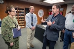 Capt. Dianna Wolfson, commander of Puget Sound Naval Shipyard & Intermediate Maintenance Facility, with Michael O. Cannon (right), director of Defense Logistics Agency Disposition Services and Bruce Bordenick (center), executive director of Radiological Controls, PSNS & IMF, discuss the benefits of the Demilitarization as a Condition of Sale contracting program.