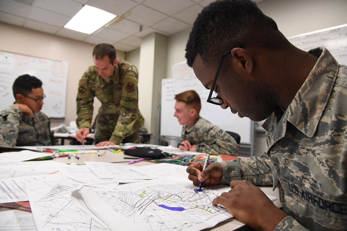 U.S. Air Force Airman 1st Class Agyei Butler, 335th Training Squadron instructor, plots data on weather charts used for training inside of the Joint Weather Training Facility at Keesler Air Force Base, Mississippi, Jan. 27, 2020. The weather apprentice course, which graduated 650 students this past year, takes 151 academic days to complete. Approximately 7,400 students go through the 335th TRS’s 13 Air Force Specialty Codes each year. (U.S. Air Force photo by Kemberly Groue)