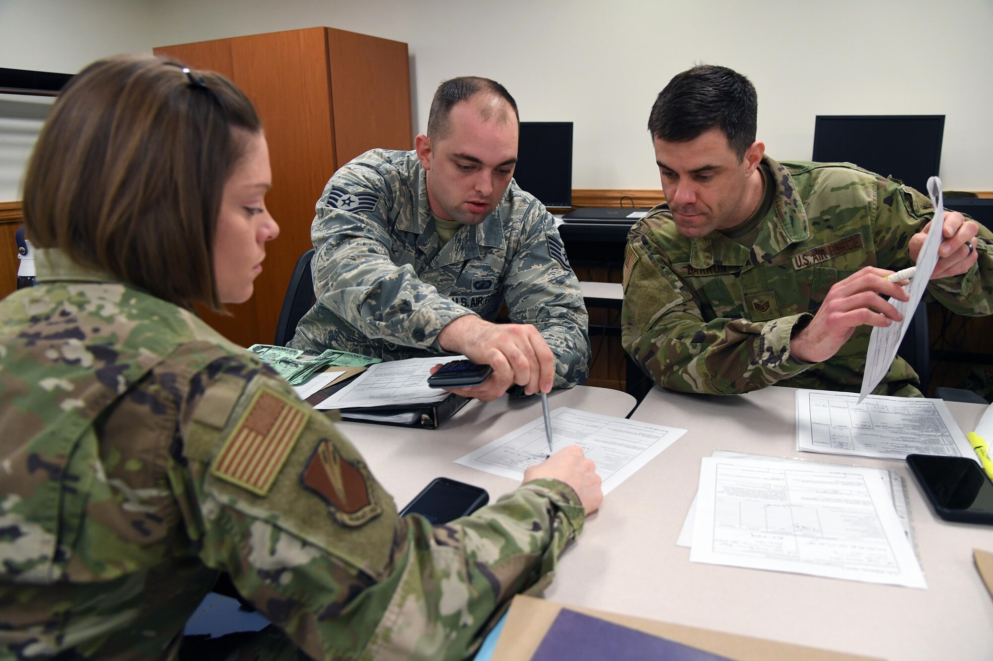U.S. Air Force Staff Sgts. Briana Lutes, Brandon Arp and Jeffery Barron, 335th Training Squadron students, complete class work for the finance management course inside Allee Hall at Keesler Air Force Base, Mississippi, Feb. 3, 2020. This course, which graduated 220 students this past year, takes nine academic days to complete. Approximately 7,400 students go through the 335th TRS's 13 Air Force Specialty Codes each year. (U.S. Air Force photo by Kemberly Groue)