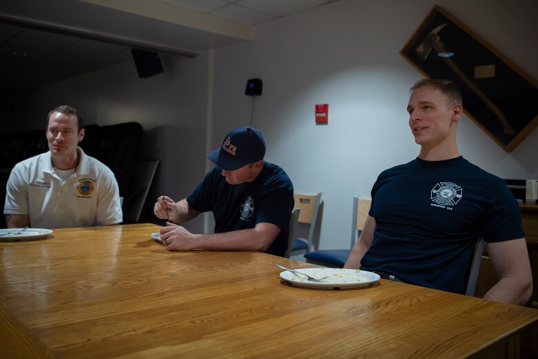 (From left) Jon Rinesmith, 50th Civil Engineer Squadron fire department station captain, Tyler Rich, 50th CES firefighter, and Spencer Obenchain, 50th CES firefighter, eat breakfast at Schriever Air Force Base, Colorado, March 6, 2020. 50th CES firefighters work 48-hour shifts followed by 72 hours off-duty, meaning they live at the firehouse four days of the week barring overtime requirments. (U.S. Air Force photo by Airman 1st Class Jonathan Whitely)
