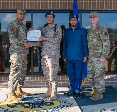 U.S. Air Force Lt. Col. Elber Mose, 81st Training Support Squadron commander, presents Royal Saudi air force Senior Master Sgt.. Obaid Al-Bogami, 81st TRSS Military Training Leader course student, with a certificate of training during the MTL course graduation ceremony outside the Levitow Training Support Facility at Keesler Air Force Base, Mississippi, March 5, 2020. Al-Bogami was the first international student the MTL schoolhouse graduated in approximately three years.  (U.S. Air Force photo by Andre' Askew)