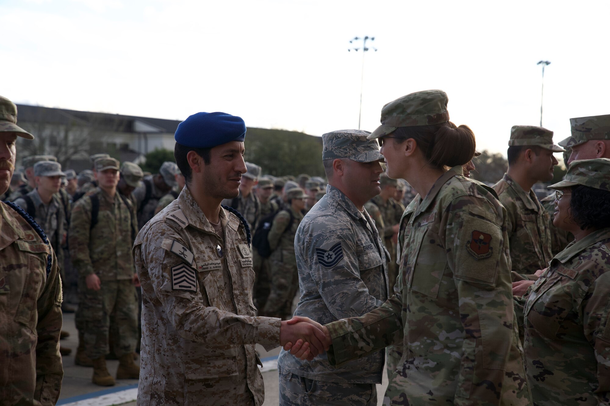 Royal Saudi air force Senior Master Sgt. Obaid Al-Bogami, 81st Training Support Squadron Military Training Leader course student, shakes hands with U.S. Air Force Col. Heather Blackwell, 81st Training Wing commander, during the MTL course graduation ceremony outside the Levitow Training Support Facility at Keesler Air Force Base, Mississippi, March 5, 2020.  Al-Bogami was the first international student the MTL schoolhouse graduated in approximately three years. (U.S. Air Force photo by Airman 1st Class Spencer Tobler)