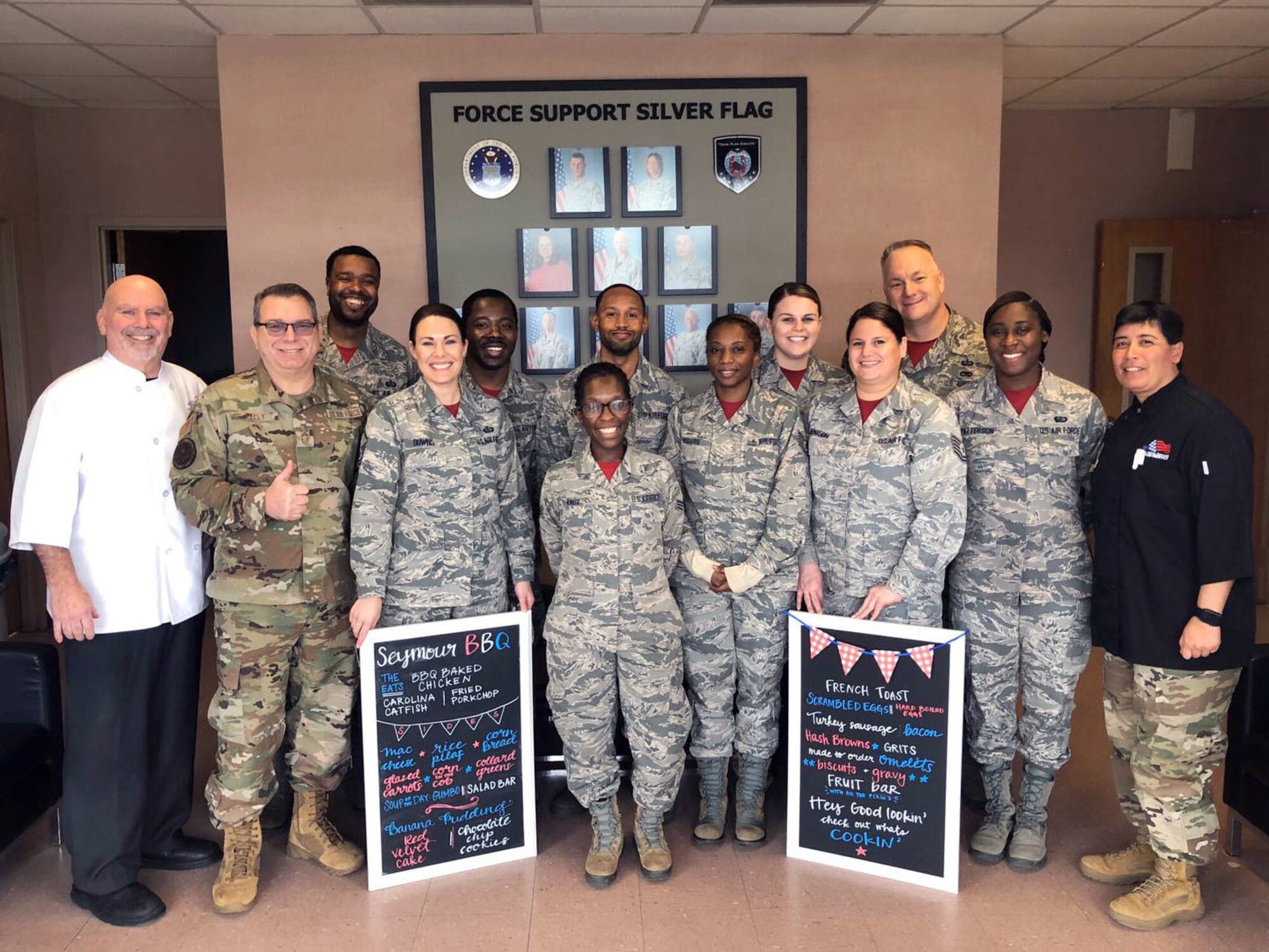Members of the 916th Force Support Squadron pose for a photo with Hennessy Award judges.