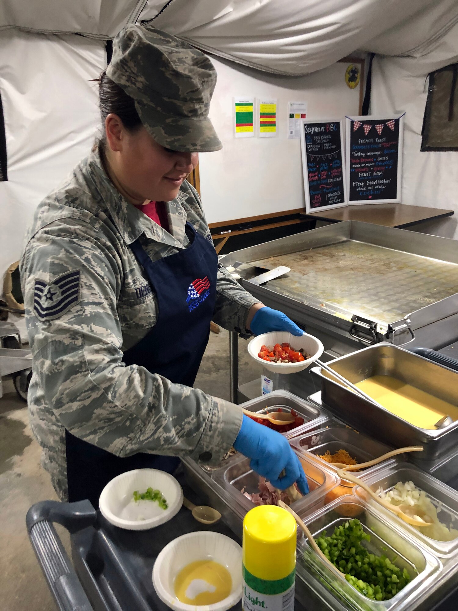 Tech Sgt. Kathleen H. Denison prepares food for an omelet.